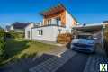 Foto Einfamilienhaus auf sonnigem Grundstück in architektonischer Bauweise