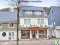 Foto Mehrfamilienhaus mit Geschäften